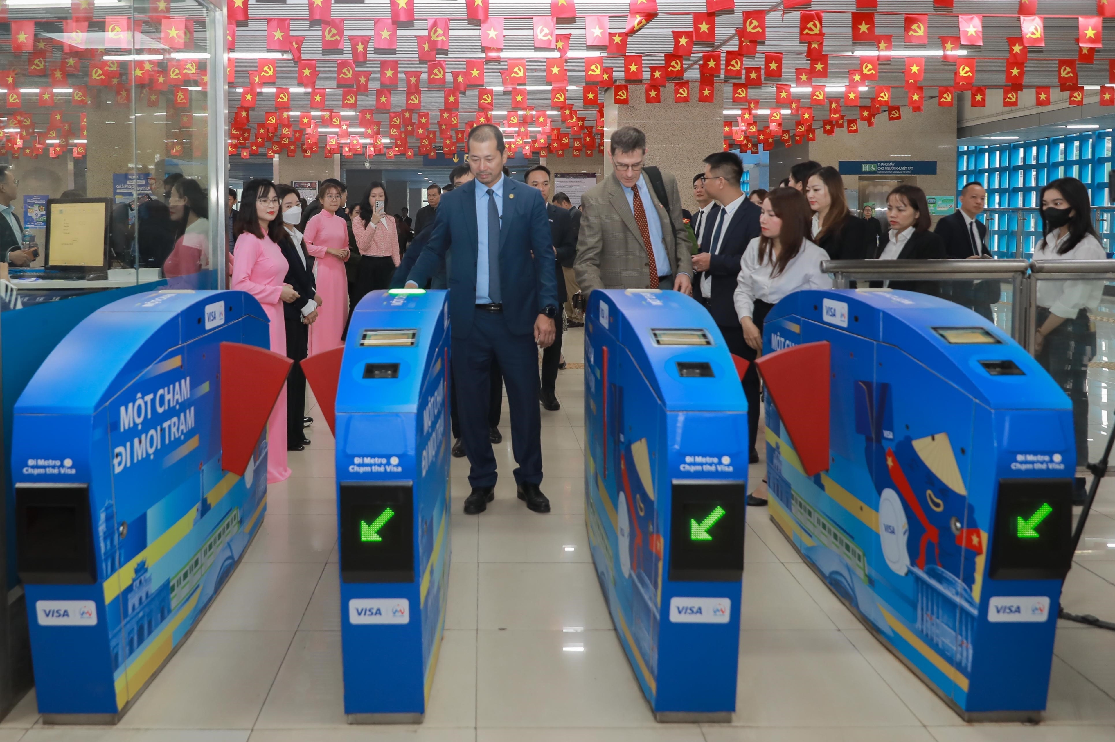 Hành khách đi tàu sử dụng hệ thống soát vé tự động ứng dụng định danh, xác thực điện tử, nhận diện sinh trắc học và thanh toán không dùng tiền mặt đối với hành khách trên tuyến đường sắt 2A Cát Linh – Hà Đông. (Ảnh: Phan Phương/TTXVN)